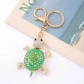 Close-up of golden turtle keychain with sparkling green and white rhinestones and opal shell - Turtle 5 (Green)