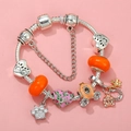 Detail of silver snake chain bracelet featuring orange glass beads and paw print charms - Sl023318/1216-18