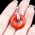 Polished red jasper donut pendant with silver bail shown in a detailed close-up view - 20mm Red Jasper