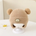 Winter knit baby bonnet with earflaps and double pom-poms in light khaki shade - Letter M - Khaki