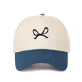 Detail of two-tone beige and navy truck hat featuring black bow embroidery on the crown - Adjustable / Dark Blue