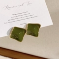 Detailed view of vintage square enamel earrings in dark green and gold on a romantic card - Olive Green