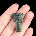 Green crystal gemstone coconut tree pendant held in hand for DIY jewelry making - India Agate