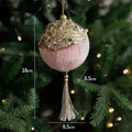 Pink velvet Christmas ornament with gold sequins and tassel hanging on a tree - Pink Ball Ornament