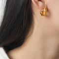 Gold plated C-shaped earrings with black zircon dots on model at 45-degree angle - Thick C-Shape / Gold Black Zirconia