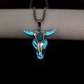 Luminous bull skull pendant with turquoise stone glowing blue in dark environment - Blue Light