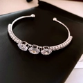 Silver bow cuff bracelet featuring oval clear zircons and pavé diamonds on a black base - Style 23 / Silver