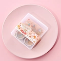 Close-up of decorative floral washi tape set in a pink box on a ceramic tray - Girl-Orange Set