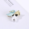 Macro shot of a cartoon tooth brooch with blue sun hat and black sunglasses on a coat - Light Blue