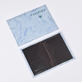 Detail view of light blue marble PU leather passport holder with inner black card slots - Light Blue