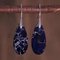 Detail of teardrop blue imperial stone earrings hanging on a natural wooden branch - Blue Network Texture Style (ER1025-21)