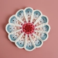 Handmade crochet flower coaster with red, pink, and blue gradient knit petals - No. 3 Gradient