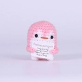 Pink and white crocheted positive penguin doll holding a motivational card on white background - Pink Penguin