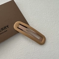 Matte brown candy-colored hair clip with oval cutout design on a textured background - Frosted Snap Clip-Yellow