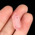 Handheld view of a natural rose quartz double-pointed hexagonal crystal prism pendant - Rose Quartz