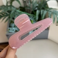 Macro detail of translucent pink matte hair claw clip with sturdy metal spring - Jelly Pink