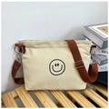 Minimalist off-white canvas crossbody bag featuring a black smiley face and brown strap - Smile Face Style / Khaki