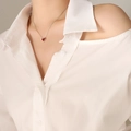 Elegant silver chain necklace with a vibrant red heart pendant worn by a female model - 40+5cm / Steel