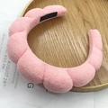 Pink twisted sponge headband with soft towel fabric texture on a wooden tray - Segmented Cloud Headband / Terry Cloth Pink