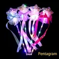 Detail of four colorful LED star magic wands with mesh lace and ribbons on black background - Starry Sky Magic Wand (Five-pointed Star)