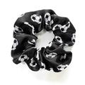 Detail shot of a black and white soccer print satin scrunchie with a silky texture - Black
