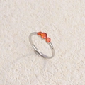 Silver titanium steel ring featuring three vibrant orange stones in a claw setting - Steel Red Zircon / Size 6