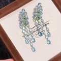 Close-up of dangling tassel earrings with light blue and green oval zircons in silver setting - Blue With Silver Needle Alloy Style