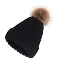 Detail of black ribbed knit beanie featuring a fluffy brown faux fur pompom on top - Black