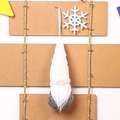 Detail of knitted Christmas gnome ornament with white plush beard on wooden background - White Type C