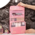 Pink hanging toiletry bag with multiple compartments and mesh pockets for travel organization - Pink