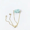 Detail of adjustable gold bolo bracelet featuring a raw light blue natural crystal stone - Amazonite