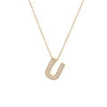 Macro shot of gold-plated letter U pendant with micro-paved sparkling cubic zirconia - Letter U