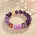 Macro view of purple amethyst beads with a heart pendant and golden stone accents - 3# Amethyst Bracelet