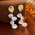 Close-up of vintage golden metal earrings with white baroque pearls on a display stand - 35# Gold Retro Irregular Pearl (Silver Earring Post)
