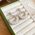 Detail shot of fan-shaped silver earrings with beige pleated leather in a jewelry box - Fan-shaped Pleated Leather Style / White
