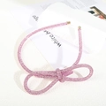 Macro detail of sparkly pink rhinestone headband with a large stereoscopic bow ornament - Figure 8 Knot Full Rhinestone Headband / Pink