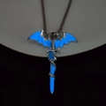 Macro view of luminous dragon sword pendant with blue glowing effect on silver metal base - Blue