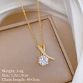 Close-up of golden cross necklace with a large round diamond in a beige jewelry box - Gold