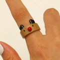 Close-up of a cute brown reindeer resin ring with a red nose and black ears on a finger - Christmas Bear Style (WG-0243)