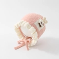 Close-up of a pink and white knitted baby bonnet with a cute bunny and bow detail - 50cm 1-2 Years / Rabbit-Pink