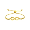 Close-up of gold infinity bracelet with clear zircon stones and adjustable chain - Lace Infinity Symbol / Lace Figure-eight Gold