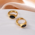 Golden stainless steel hoop earrings featuring an oval black stone on a ceramic tray - Oval Zircon / Black