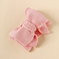 Close-up of a pink knitted baby headband with a large bow and soft yarn texture - Korean Pink