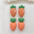 Detailed close-up of orange resin carrot accessories with green leaves for DIY crafts - Mixed Random Style