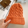 Close-up of bright orange cable knit beanie featuring thick textured wool and ribbed cuff - M (56-58cm) / Orange