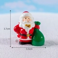 Miniature Santa Claus figurine holding a green gift bag with 3.7cm height dimensions - No.1 Santa Claus Carrying Package
