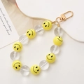 Dettaglio del ciondolo di perline con faccine gialle e moschettone in metallo dorato - Ciondolo Faccina Sorridente K1060