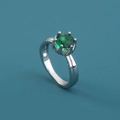Close-up of a silver ring featuring a round green gemstone in a classic prong setting - Adjustable Open / Green Round Gemstone/Prong Setting