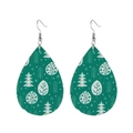 Detailed macro view of green teardrop leather earrings with white Christmas tree print - Green Christmas Forest Print