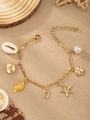Golden ocean charm bracelet featuring shells, starfish, and a white pearl on a fine chain - Letter O(O)
